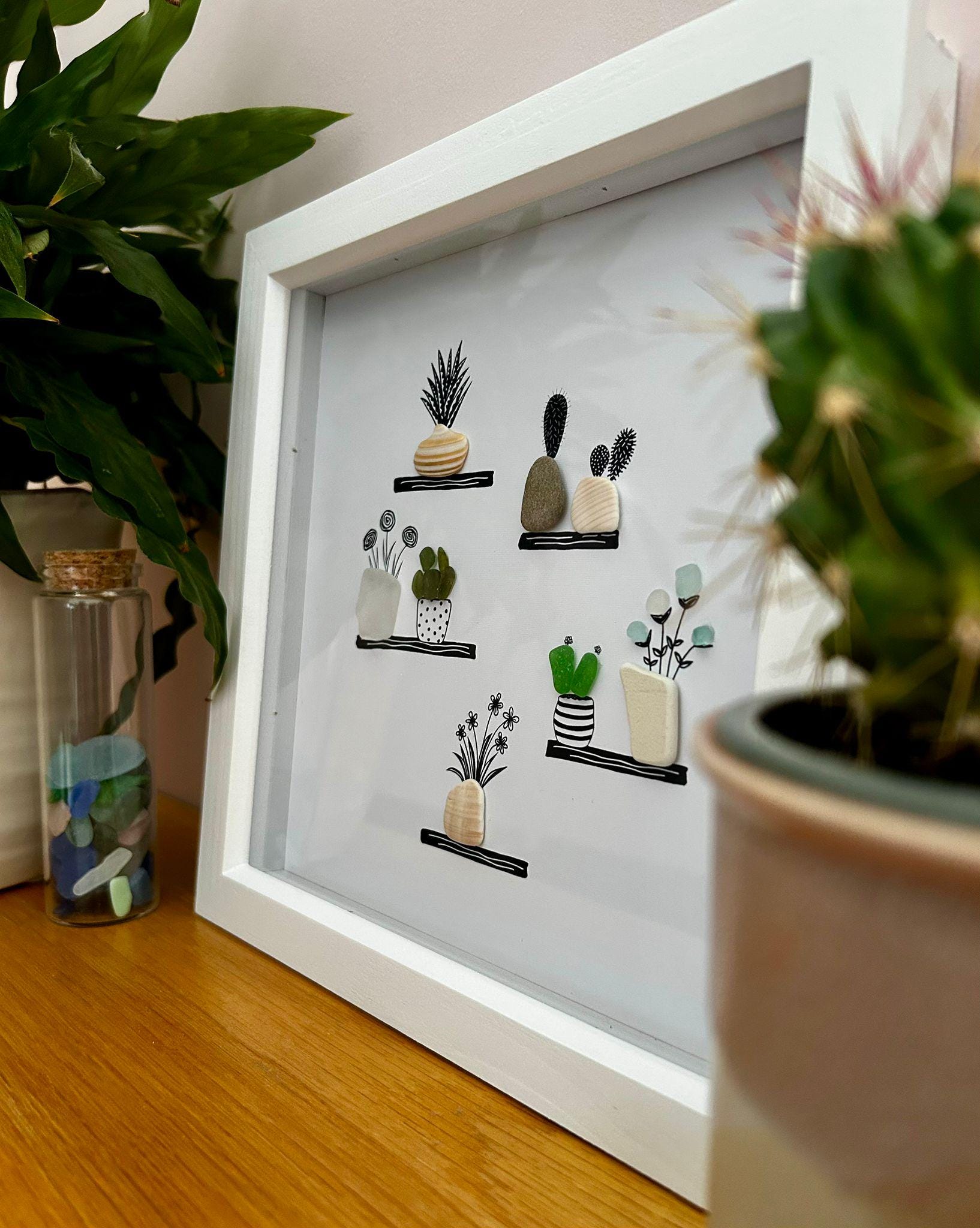 Sea Glass Flower & Pebble Plant Shelf Art – Handmade Coastal Wall Decor – Quirky Nature Picture