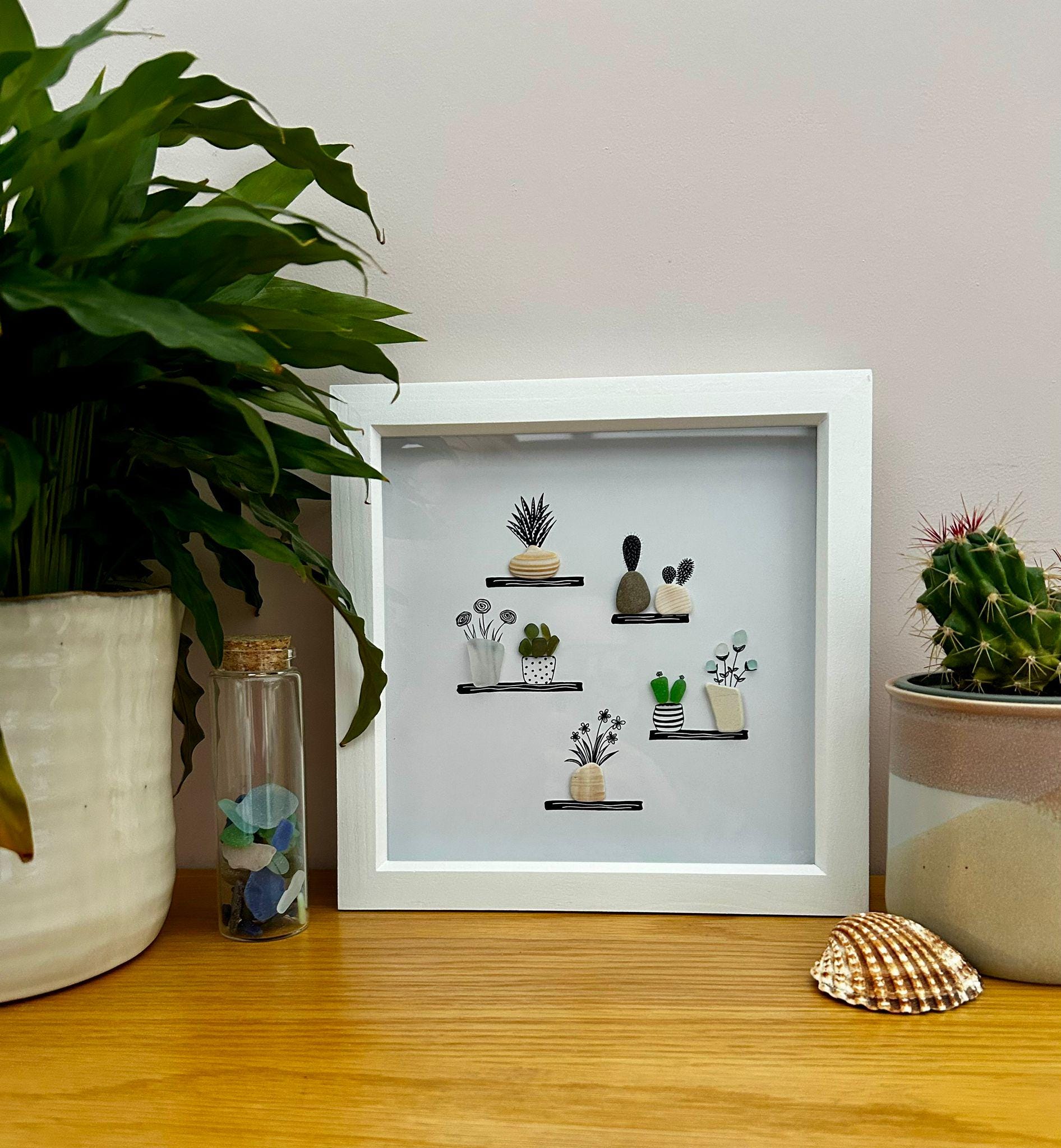 Sea Glass Flower & Pebble Plant Shelf Art – Handmade Coastal Wall Decor – Quirky Nature Picture