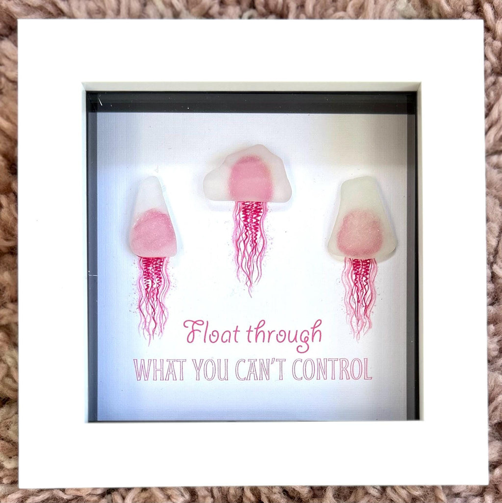 Pink sea glass jellyfish art in white frame with calming coastal quote wall decor