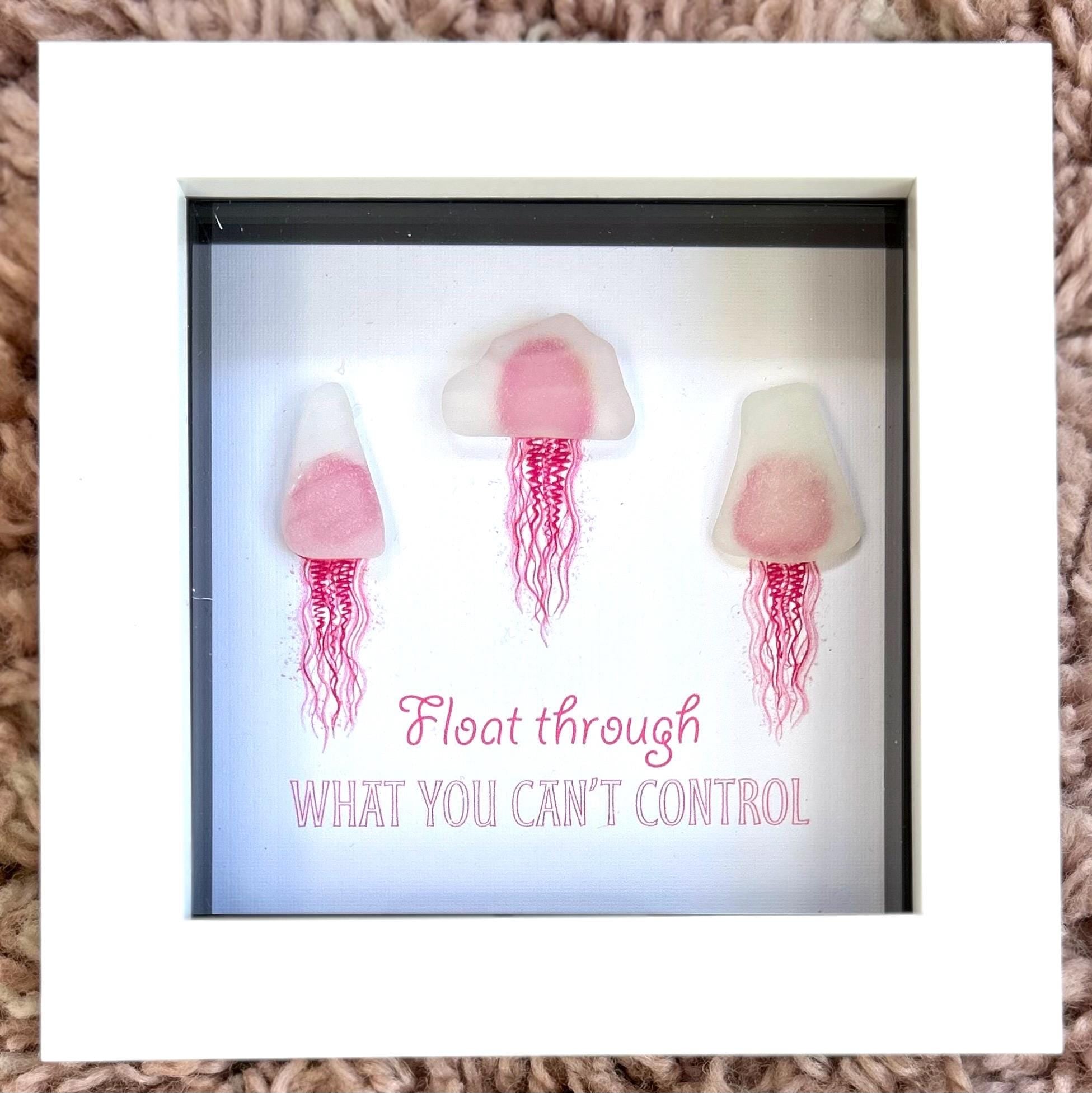 Pink sea glass jellyfish art in white frame with calming coastal quote wall decor